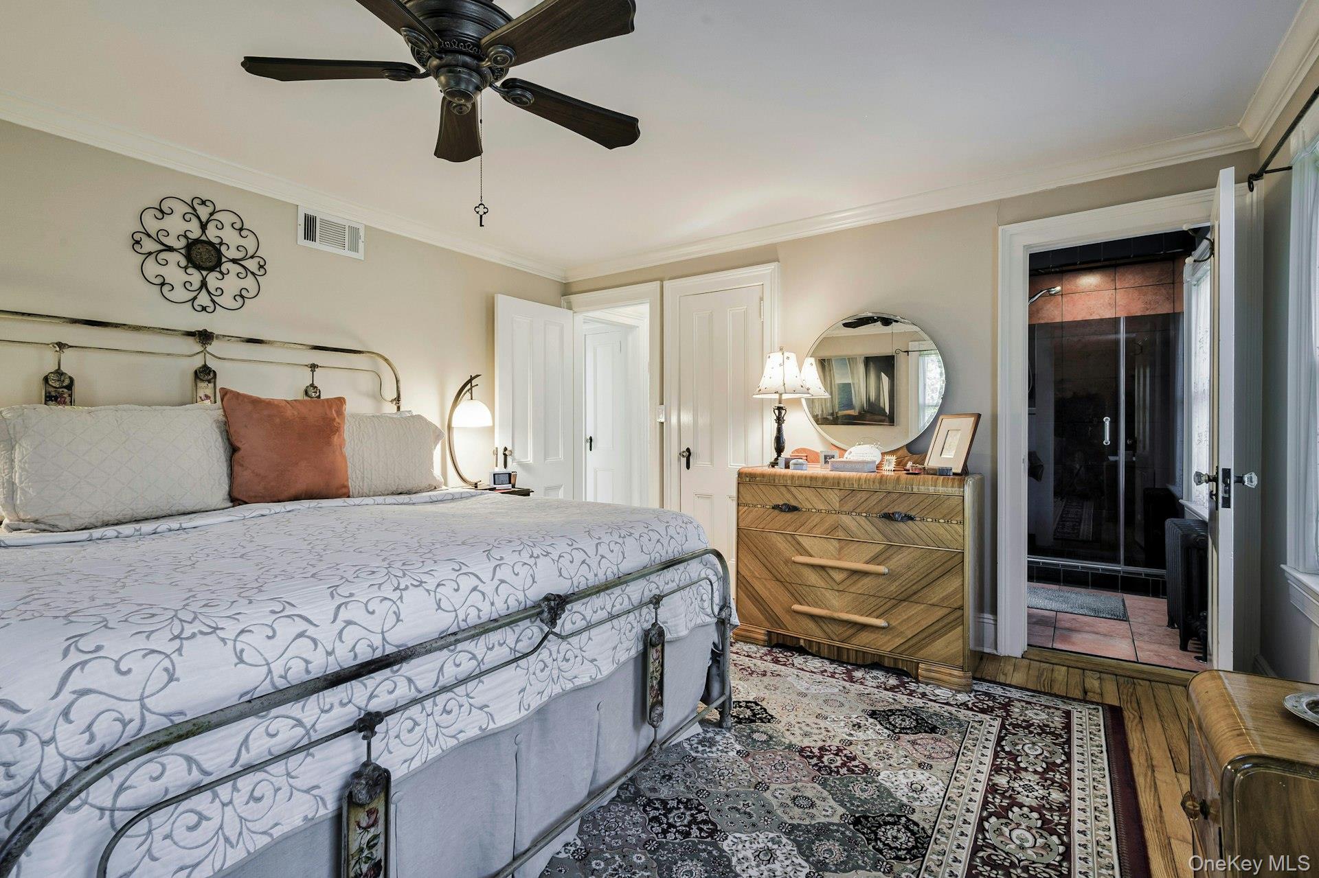 126 Cove Road Oyster Bay, NY 11771 - Photo 35 of 42 Bedroom featuring crown molding, hardwood / wood-style floors, and a ceiling fan