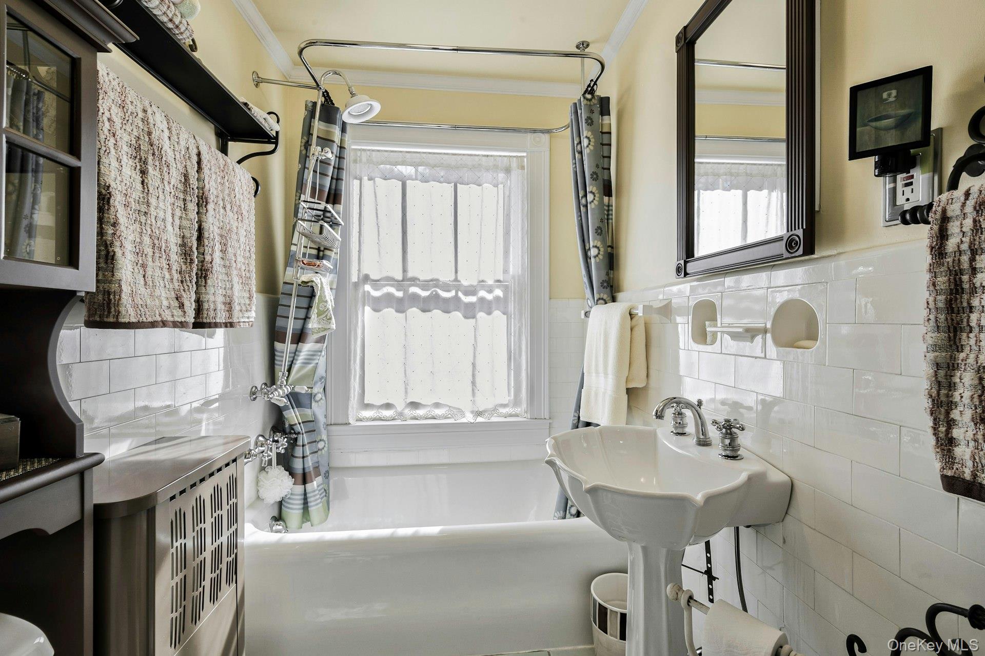 126 Cove Road Oyster Bay, NY 11771 - Photo 36 of 42 Full bathroom with tile walls, shower / bath combination with curtain, and a wainscoted wall