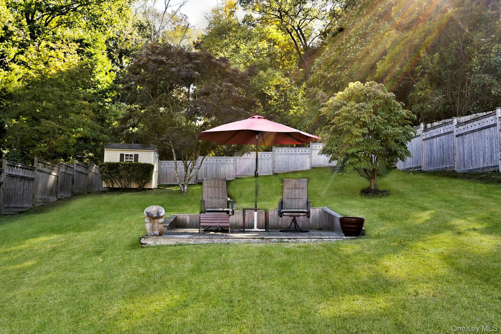 126 Cove Road Oyster Bay, NY 11771 - Photo 37 of 42 larger Fenced backyard featuring a wooden deck
