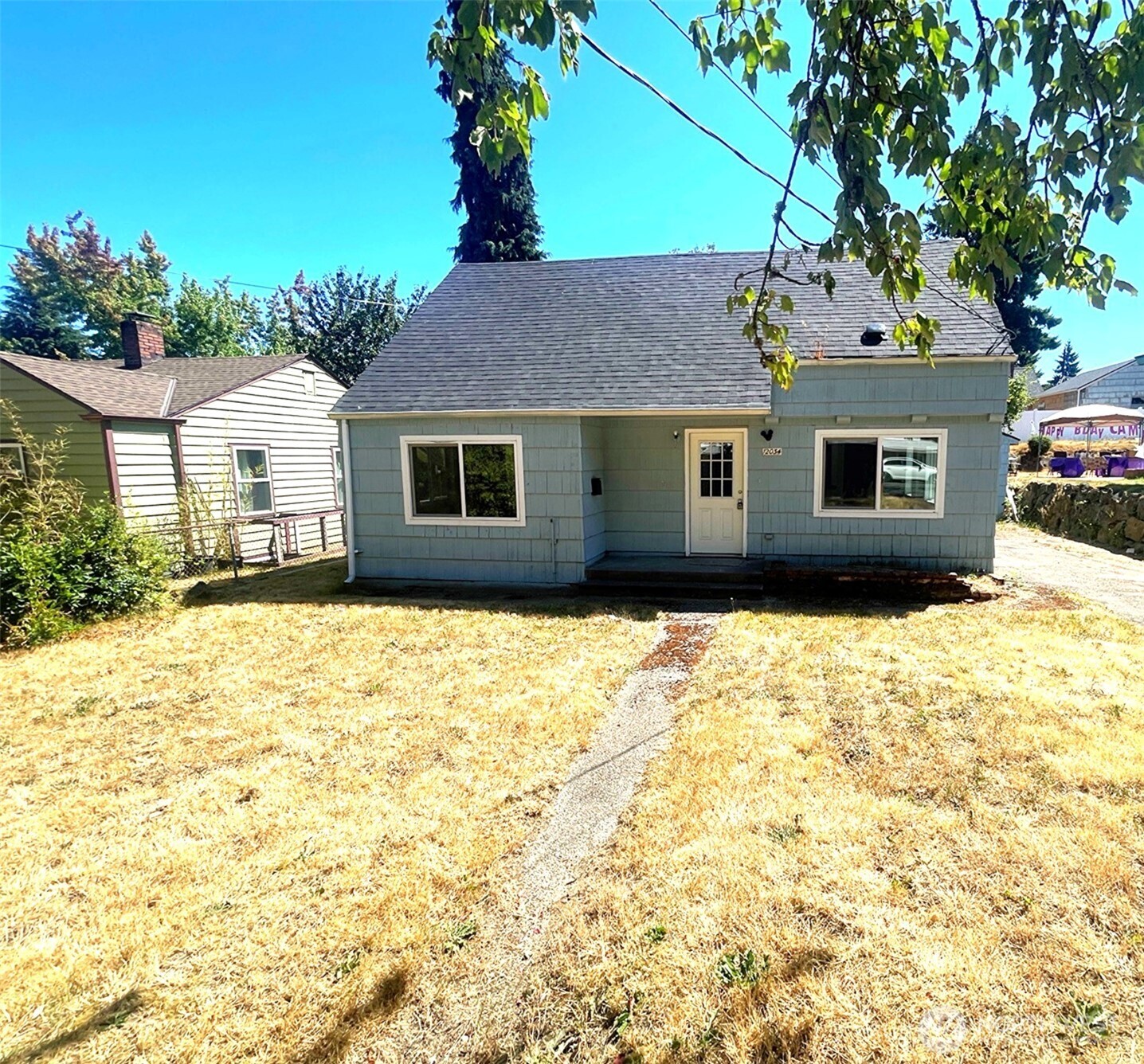 a house that has a tree in front of it