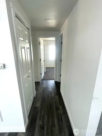 a view of a hallway and wooden floor