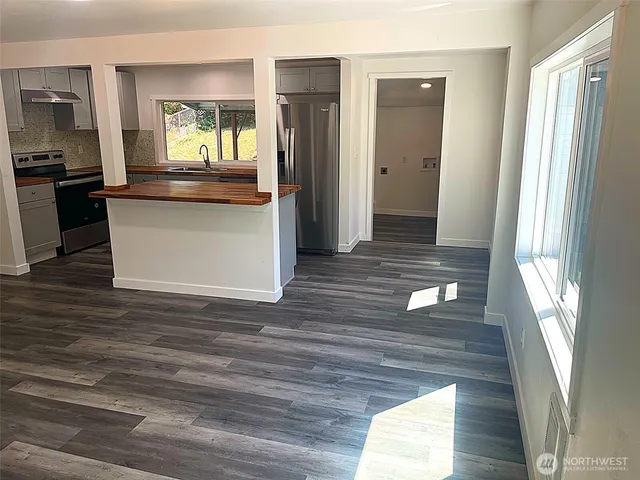 a view of a hallway view with wooden floor and dining room