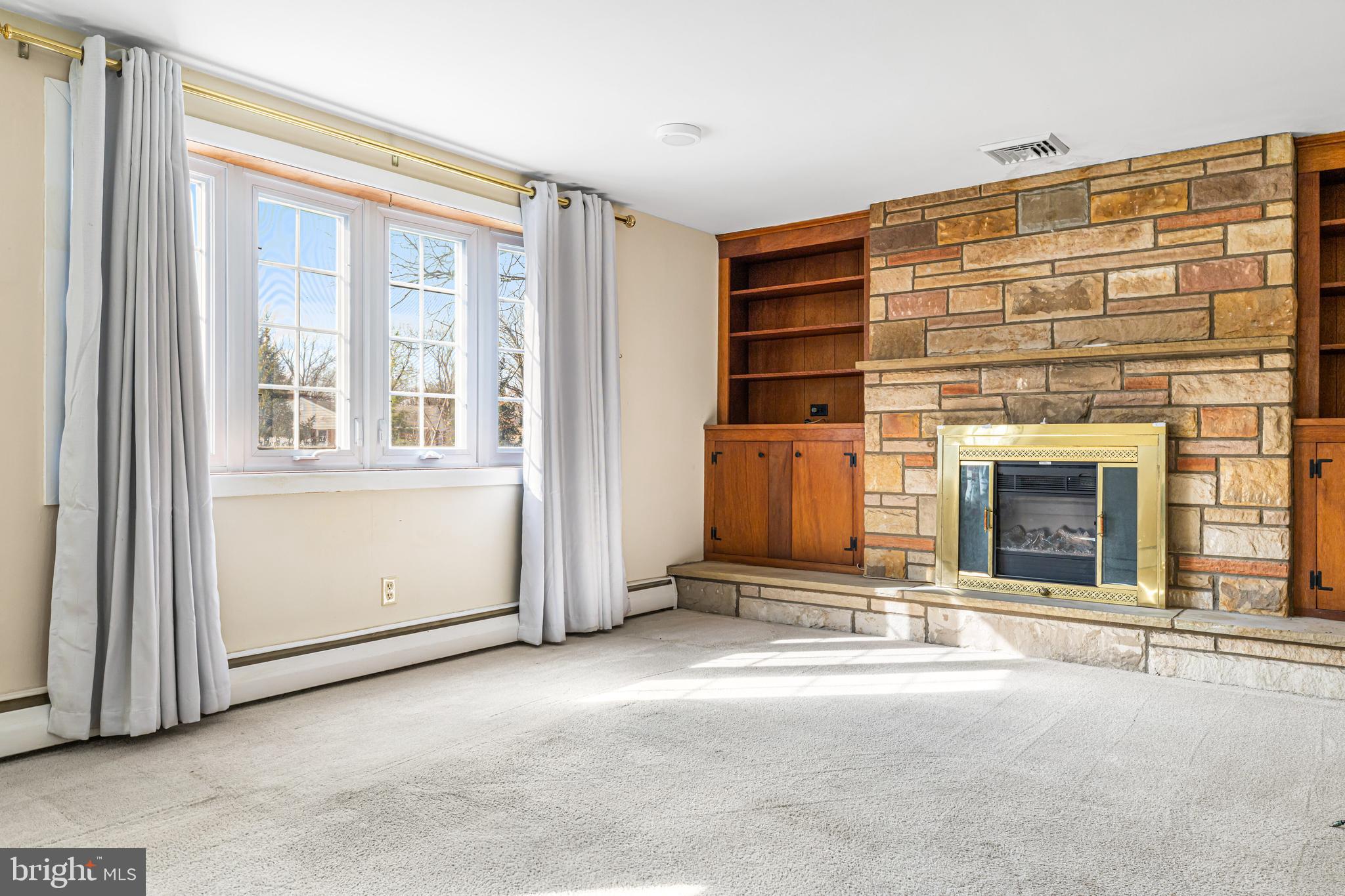 2091 Meetinghouse Road Jamison, PA 18929 - Photo 8 of 48 a view of an empty room with a fireplace and a window