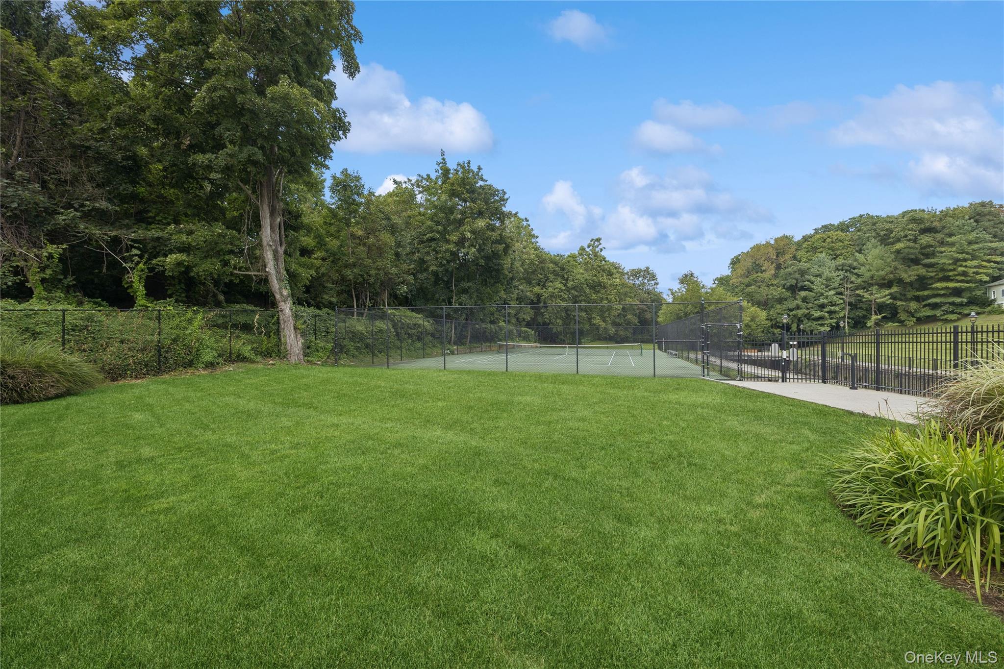 1 Scarsdale Road, Unit 613 Tuckahoe, NY 10707 - Photo 29 of 34 View of the expansive green space with tennis court.