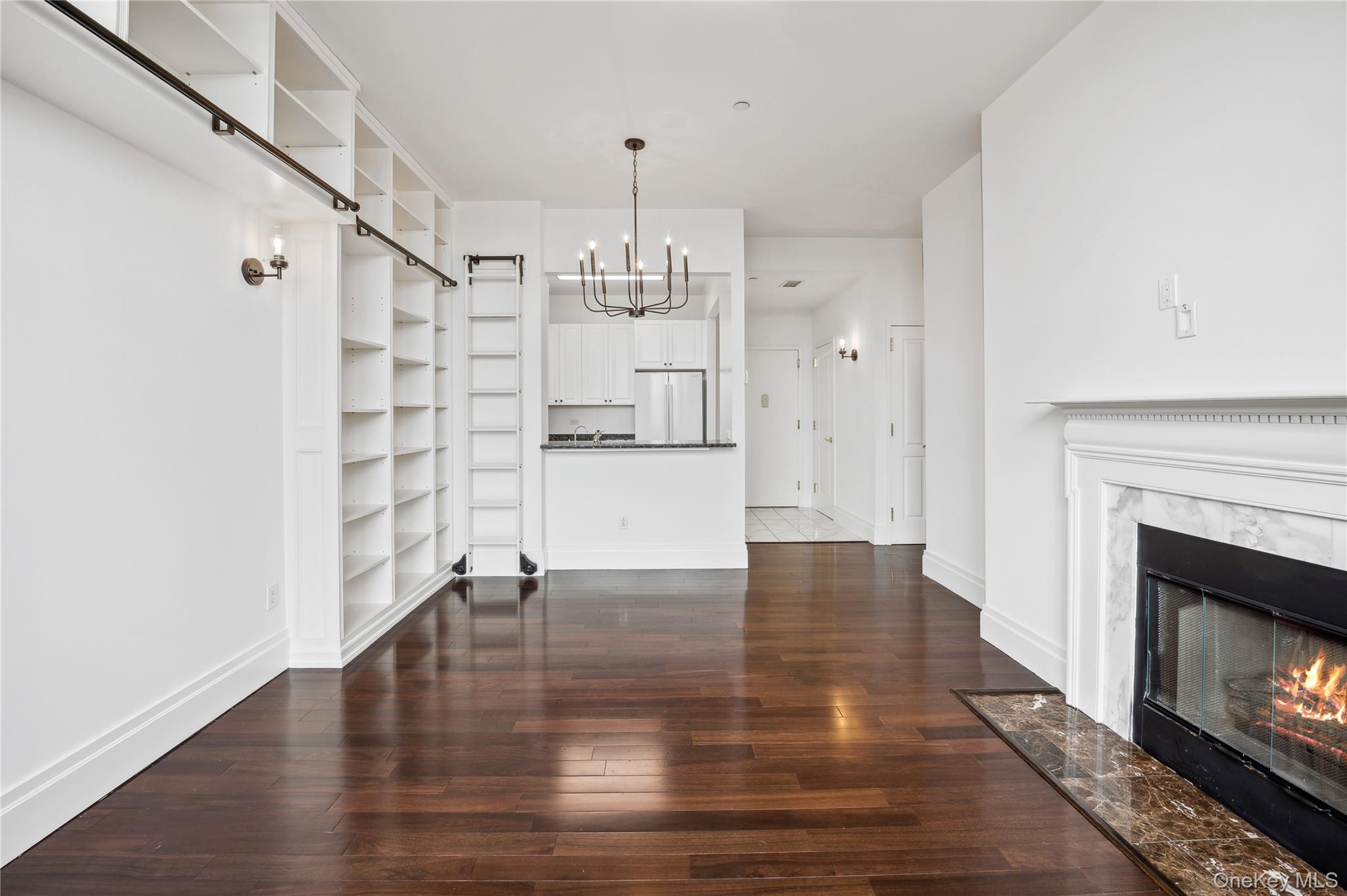 1 Scarsdale Road, Unit 613 Tuckahoe, NY 10707 - Photo 6 of 34 Living room with custom built-in bookshelves.