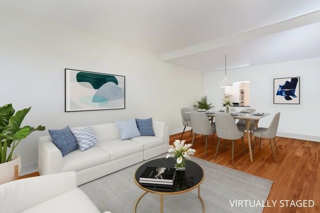 a living room with furniture a rug and a table