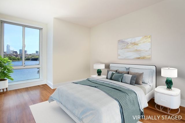 a bedroom with a bed and a large window