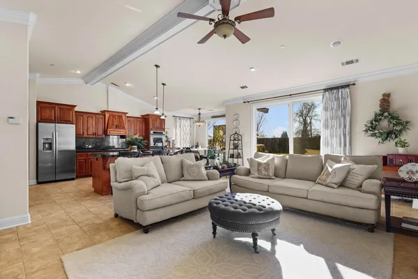 a kitchen with stainless steel appliances kitchen island granite countertop a stove a sink and a refrigerator