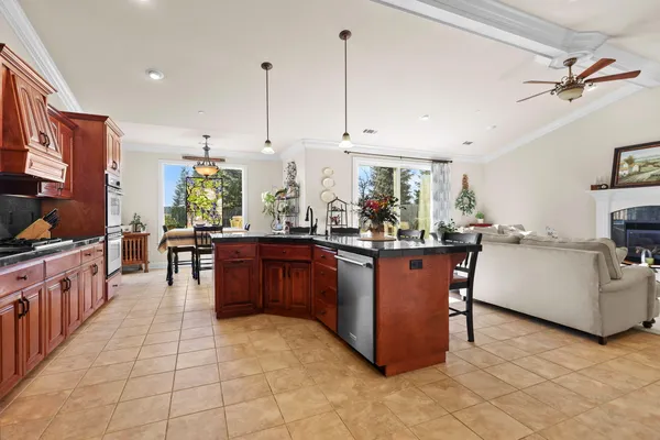 a kitchen with stainless steel appliances granite countertop a refrigerator a oven a sink and dishwasher