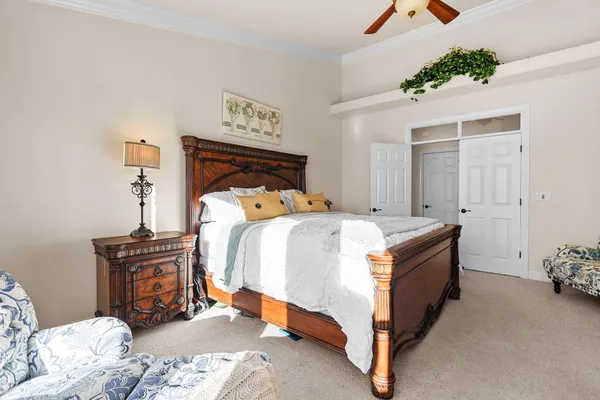 a bedroom with a bed and a mirror on the dresser