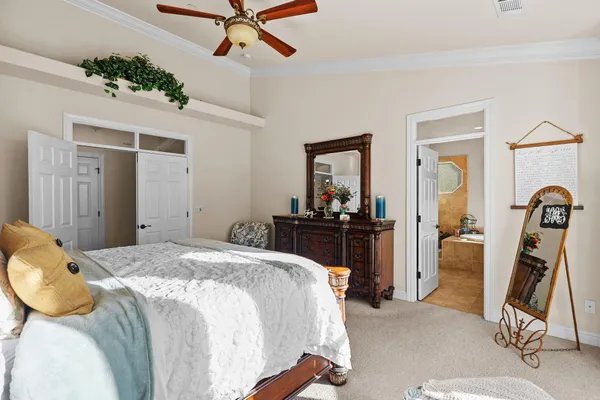 a spacious bathroom with a double vanity sink a mirror a bathtub and a toilet