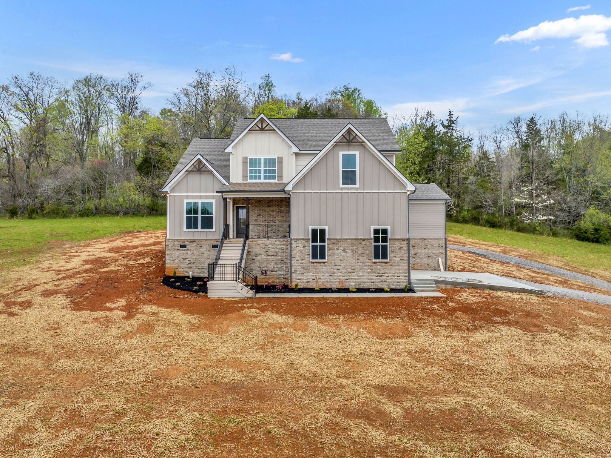 303 Noah Road Manchester, TN 37355 - Photo 1 of 63 a front view of a house with a yard and garage