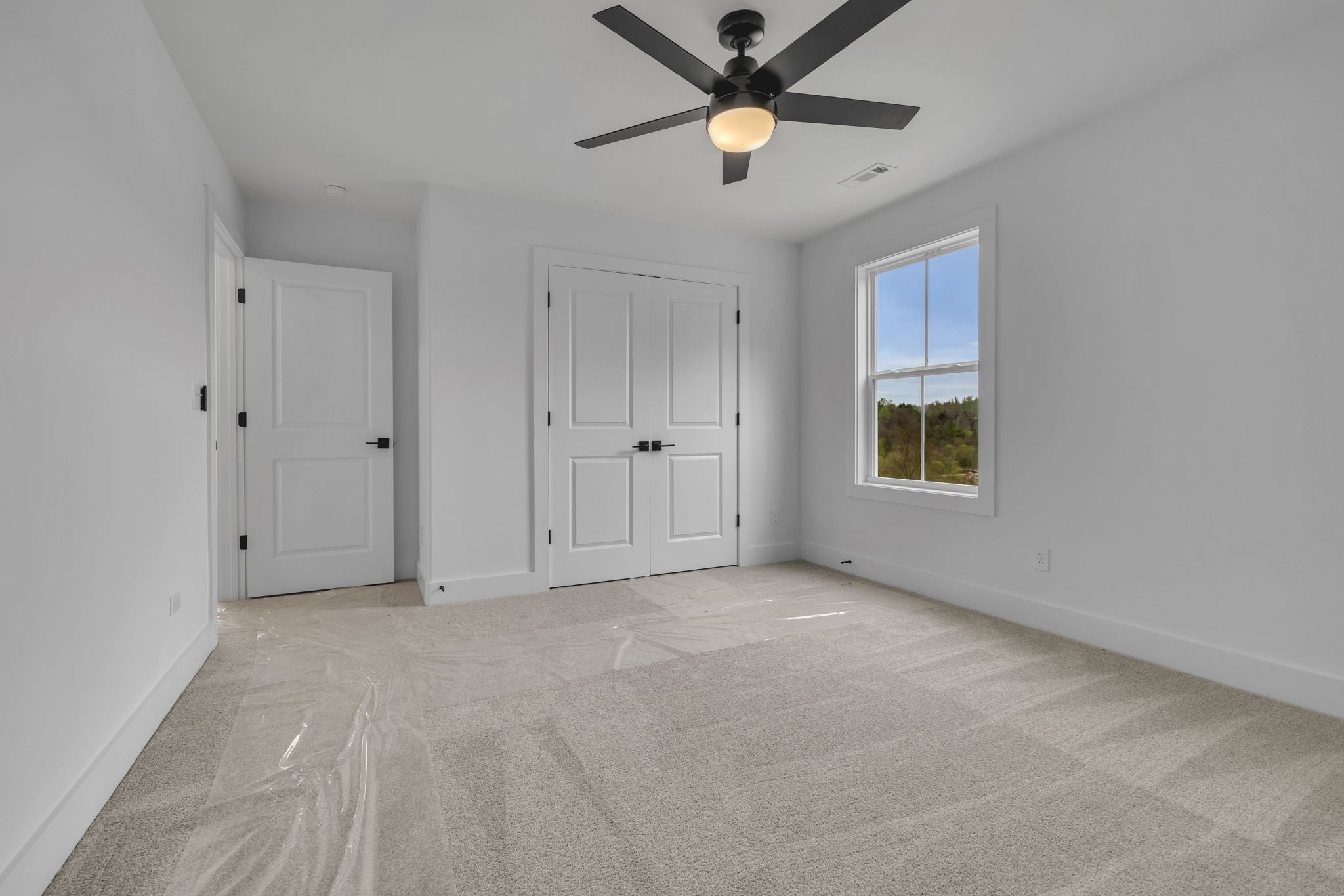 303 Noah Road Manchester, TN 37355 - Photo 38 of 63 an empty room with chandelier fan and windows