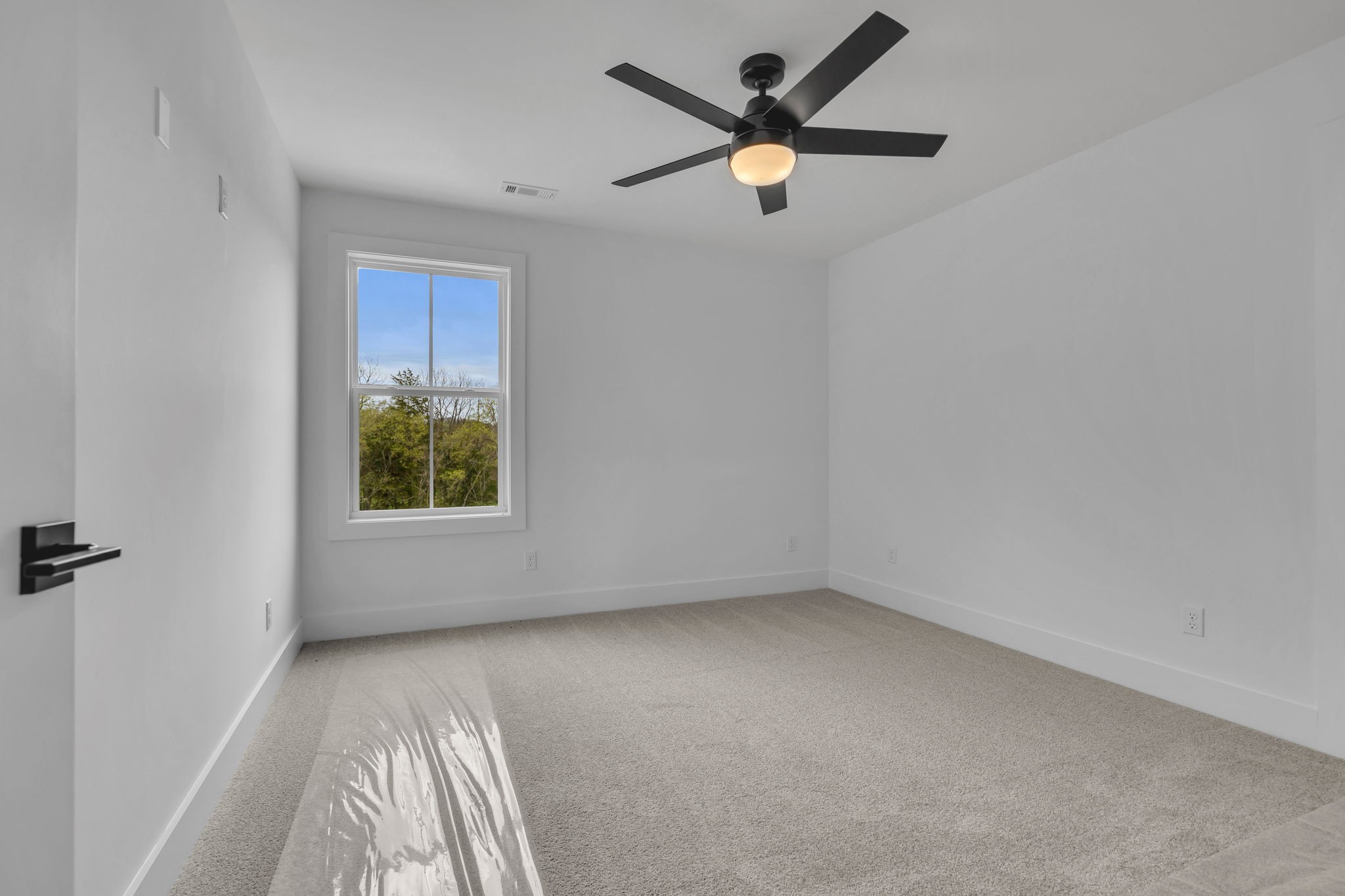 303 Noah Road Manchester, TN 37355 - Photo 41 of 63 an empty room with a window and a fan