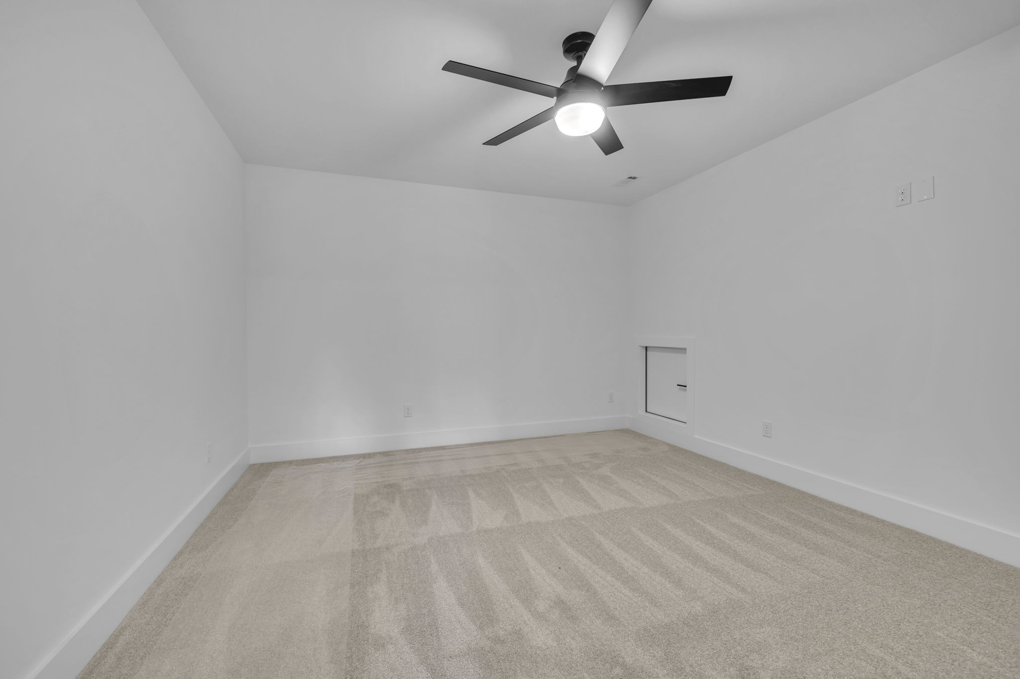303 Noah Road Manchester, TN 37355 - Photo 49 of 63 an empty room with a chandelier fan and windows