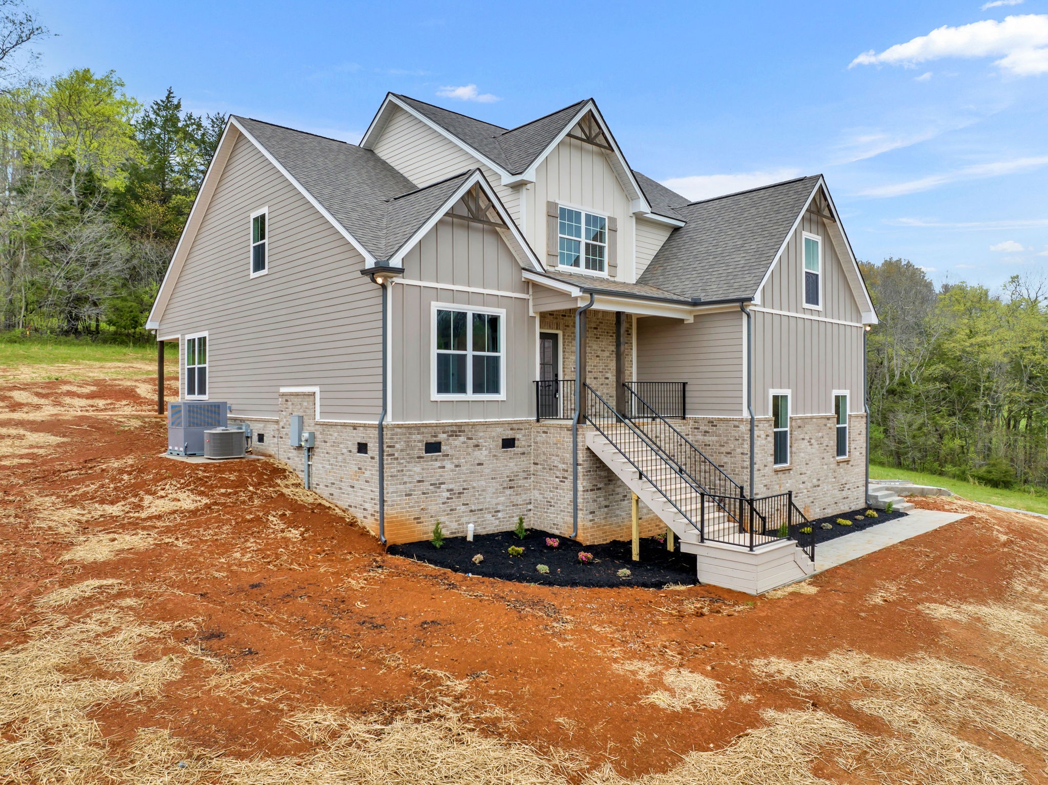 303 Noah Road Manchester, TN 37355 - Photo 54 of 63 a view of a white house next to a yard with large trees