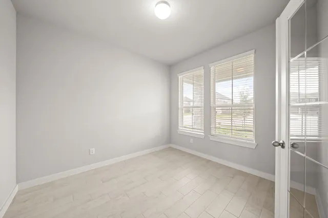 an empty room with a empty space and windows