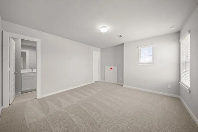 an empty room with windows and closet