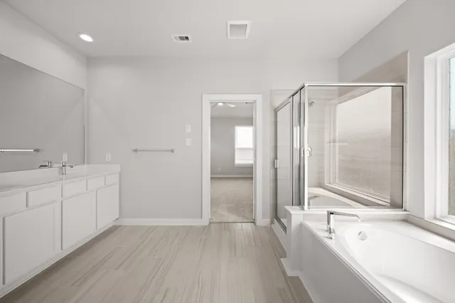 a bathroom with a tub a sink and mirrors