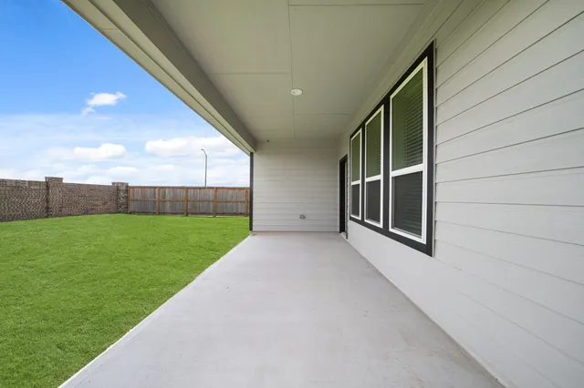 a view of an house with backyard of a house