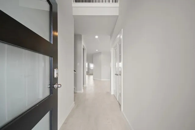 a view of a hallway with a dining area