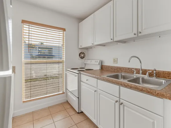 a kitchen with white cabinets and a sink