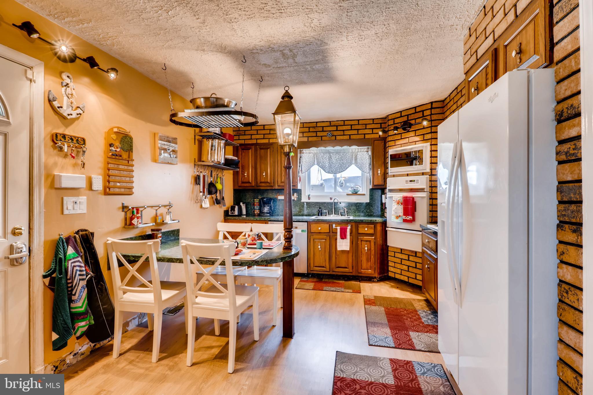 8211 Shore Road Baltimore, MD 21222 - Photo 11 of 46 Cozy, eat-in kitchen has ample cabinetry -