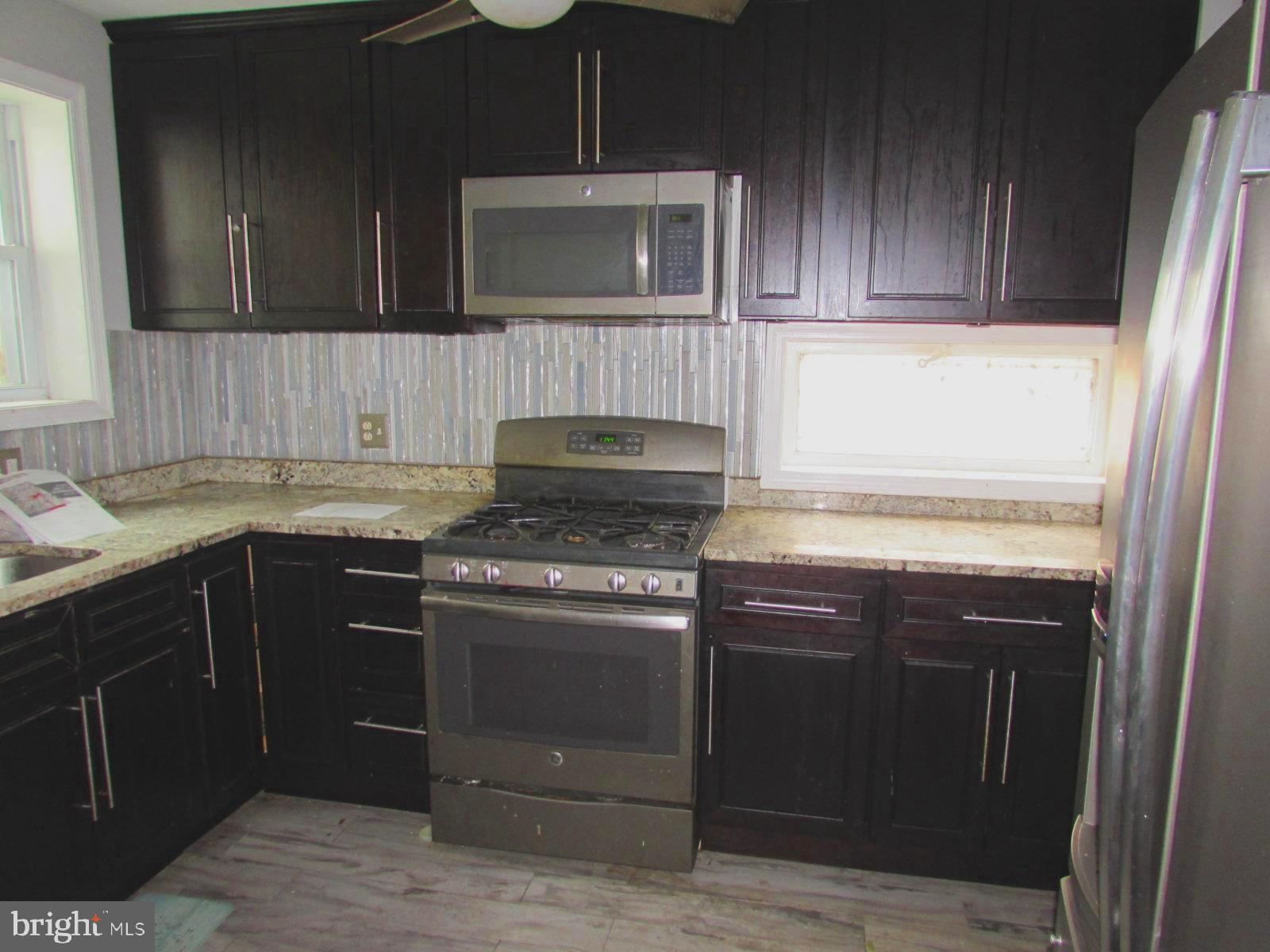 4954 8th Street Northeast Washington, DC 20017 - Photo 3 of 3 a kitchen with a stove and a microwave