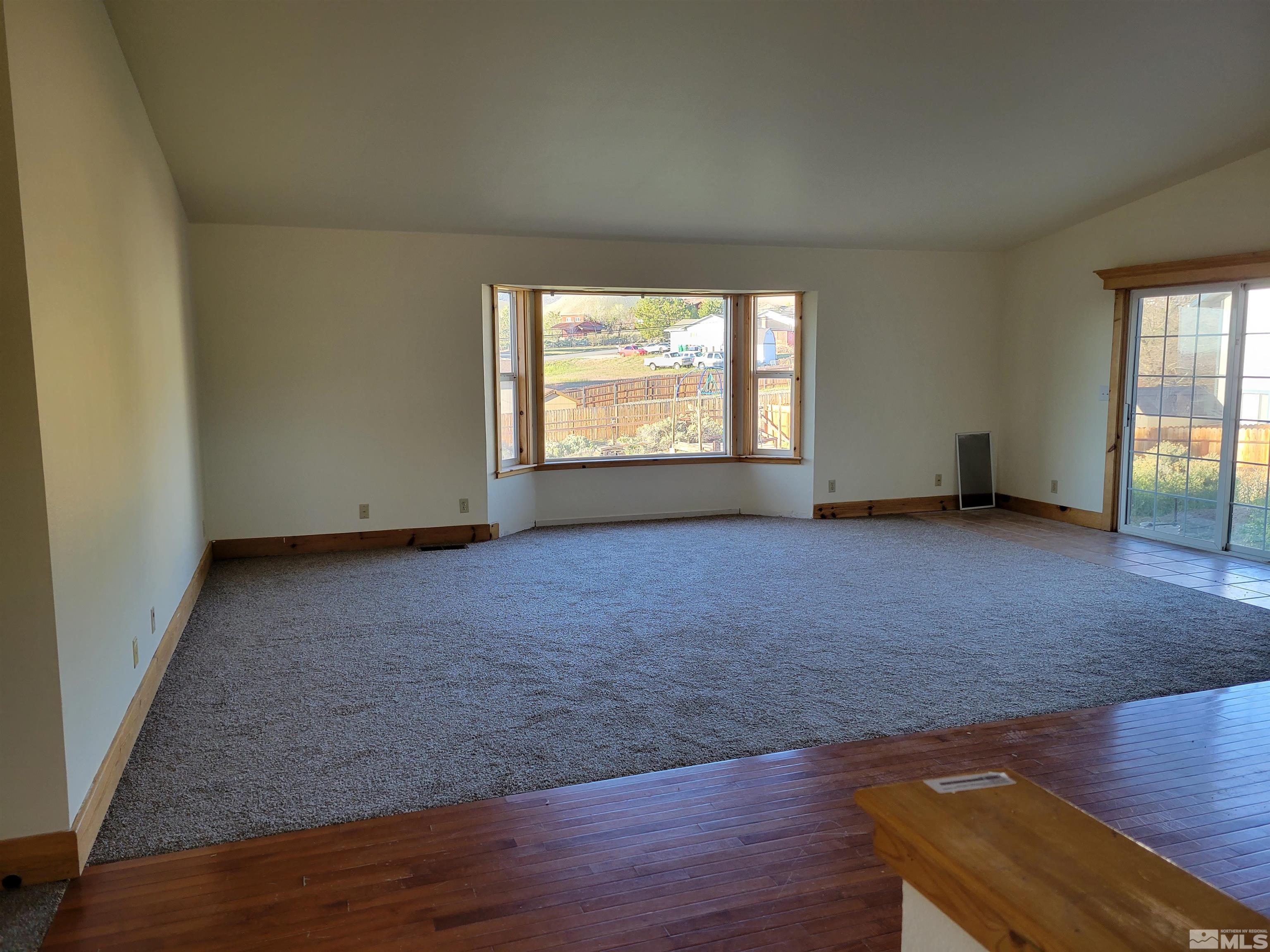 10405 Bounder Lane Reno, NV 89508 - Photo 5 of 16 an empty room with wooden floor and windows