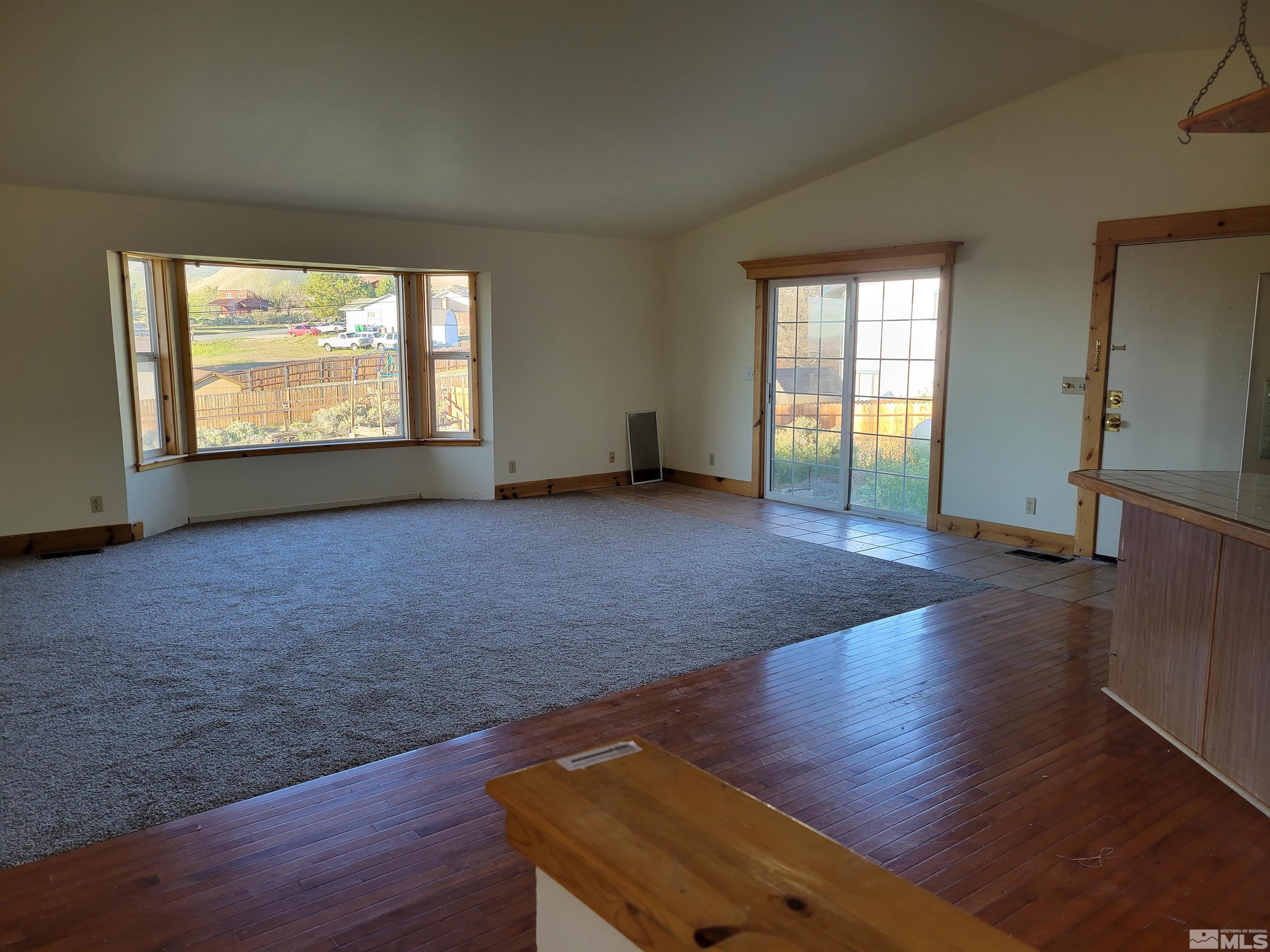 10405 Bounder Lane Reno, NV 89508 - Photo 6 of 16 a view of an empty room with wooden floor and a window