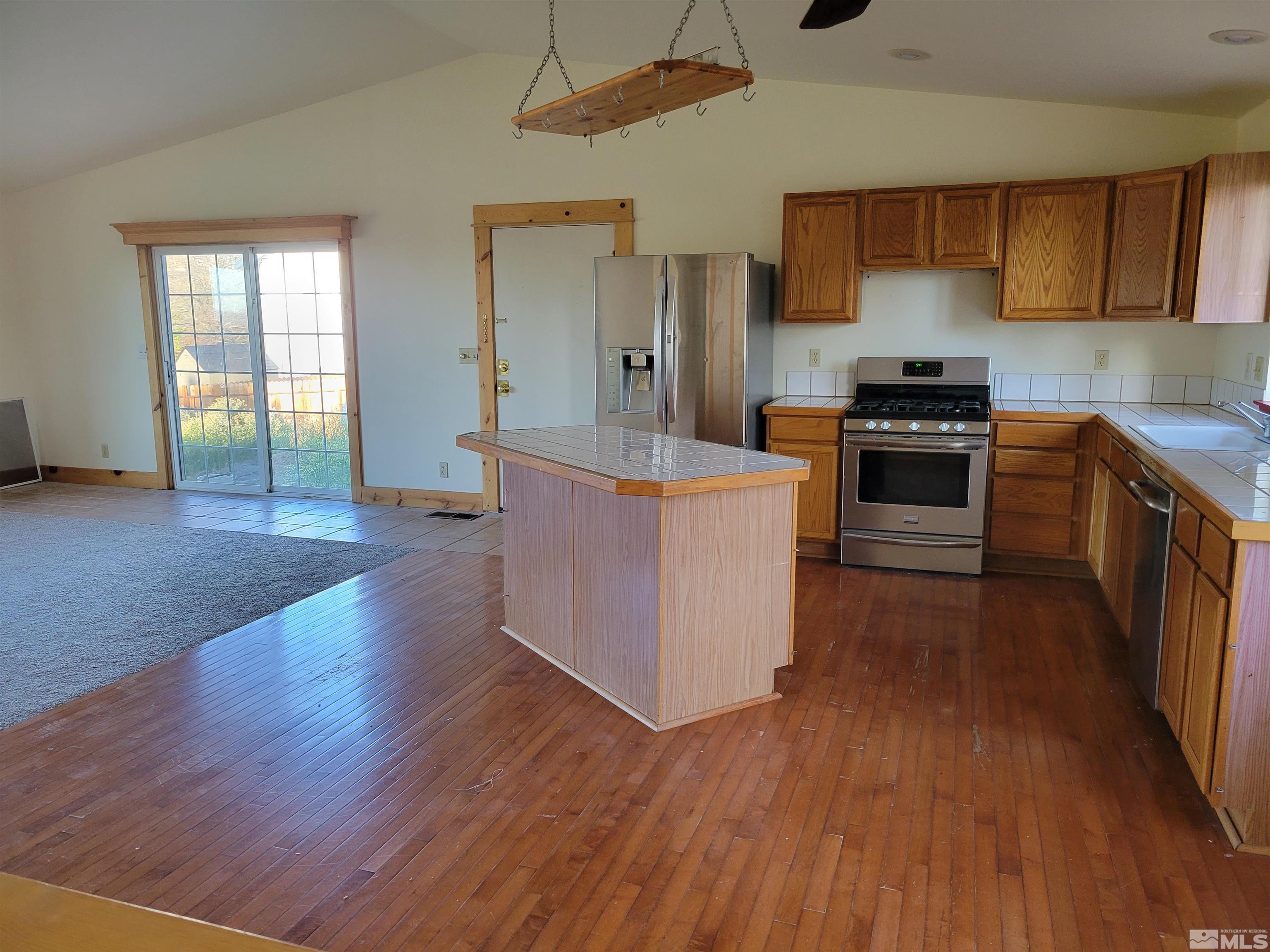 10405 Bounder Lane Reno, NV 89508 - Photo 10 of 16 a kitchen with stainless steel appliances a stove top oven a sink and a refrigerator