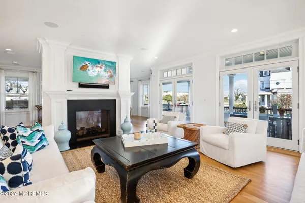 a living room with furniture fireplace and a table