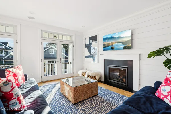 a spacious bedroom with a large bed and a chandelier