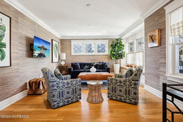a living room with furniture and a mirror