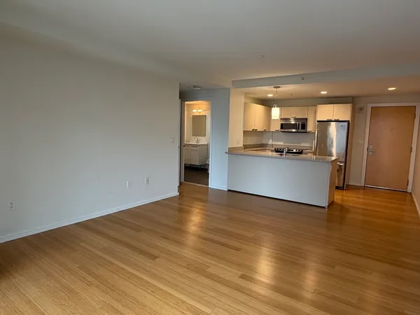 a view of a kitchen with a sink and a refrigerator