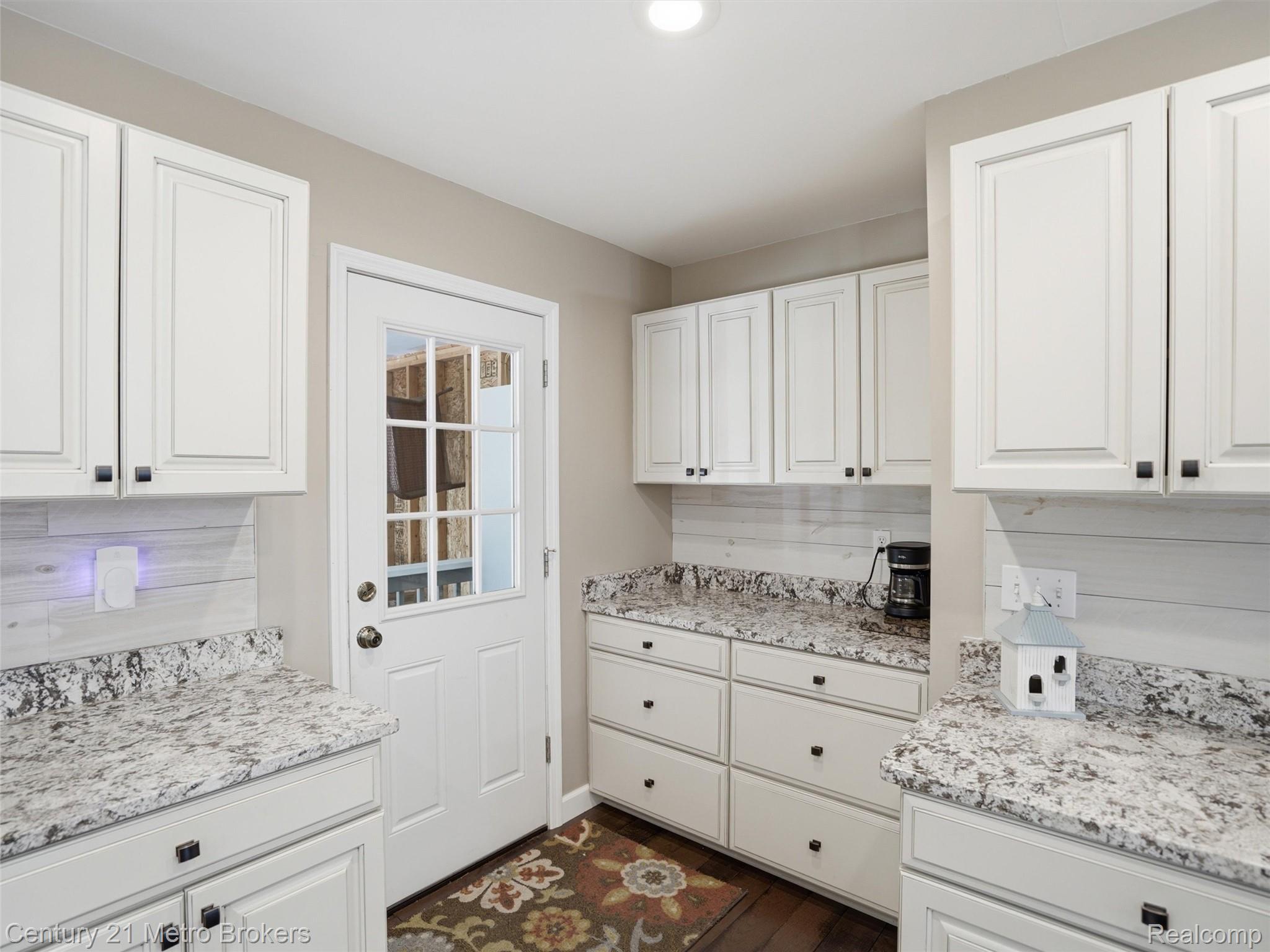 11447 North Latson Road Linden, MI 48451 - Photo 14 of 52 Bright kitchen featuring white shaker-style cabinetry with dark hardware