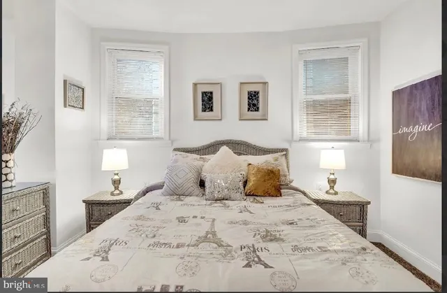 a bedroom with a large bed and a night stand