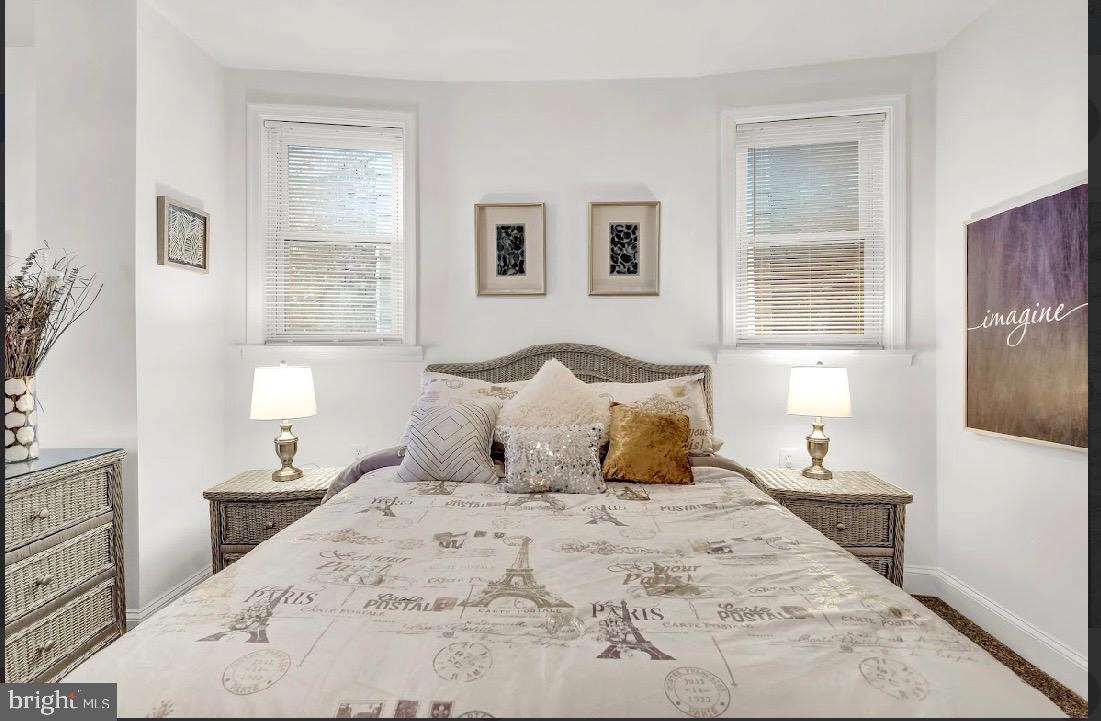 468 East Walnut Lane, Unit 1 Philadelphia, PA 19144 - Photo 11 of 17 a bedroom with a large bed and a night stand