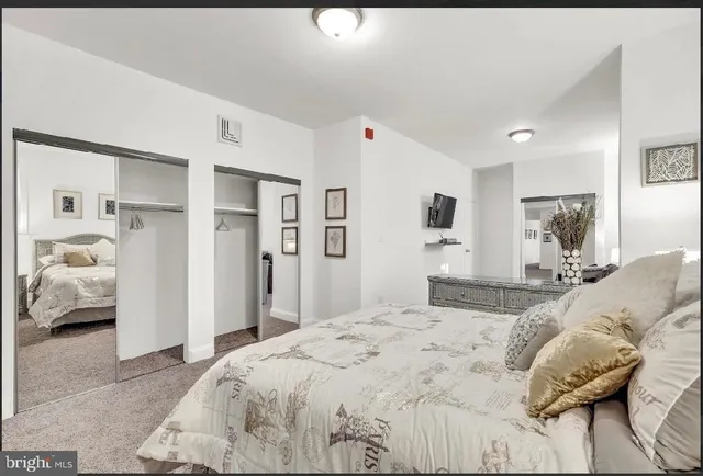 a bedroom with a large bed and a couch