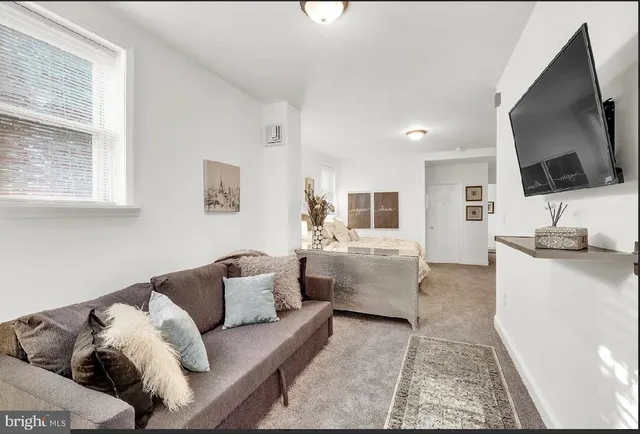 a living room with furniture and a flat screen tv
