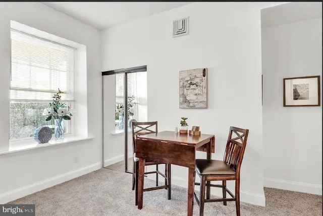 a dining room with furniture and window