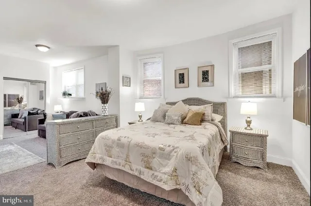 a spacious bedroom with a bed and a couch