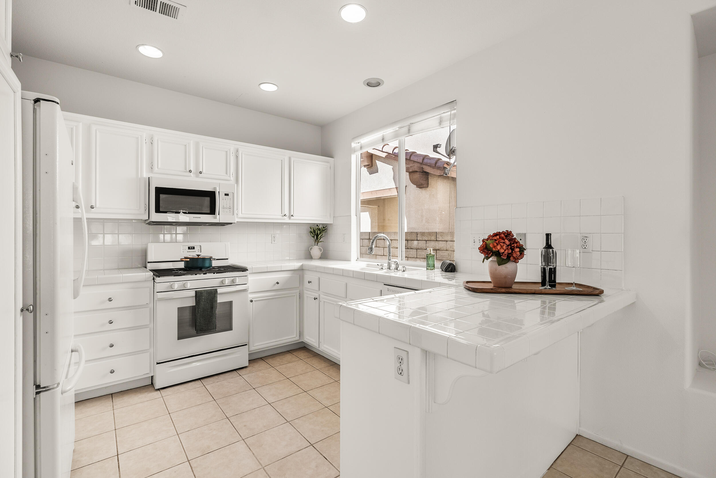 25803 Hammet Circle Stevenson Ranch, CA 91381 - Photo 11 of 32 a kitchen with granite countertop white cabinets and stainless steel appliances