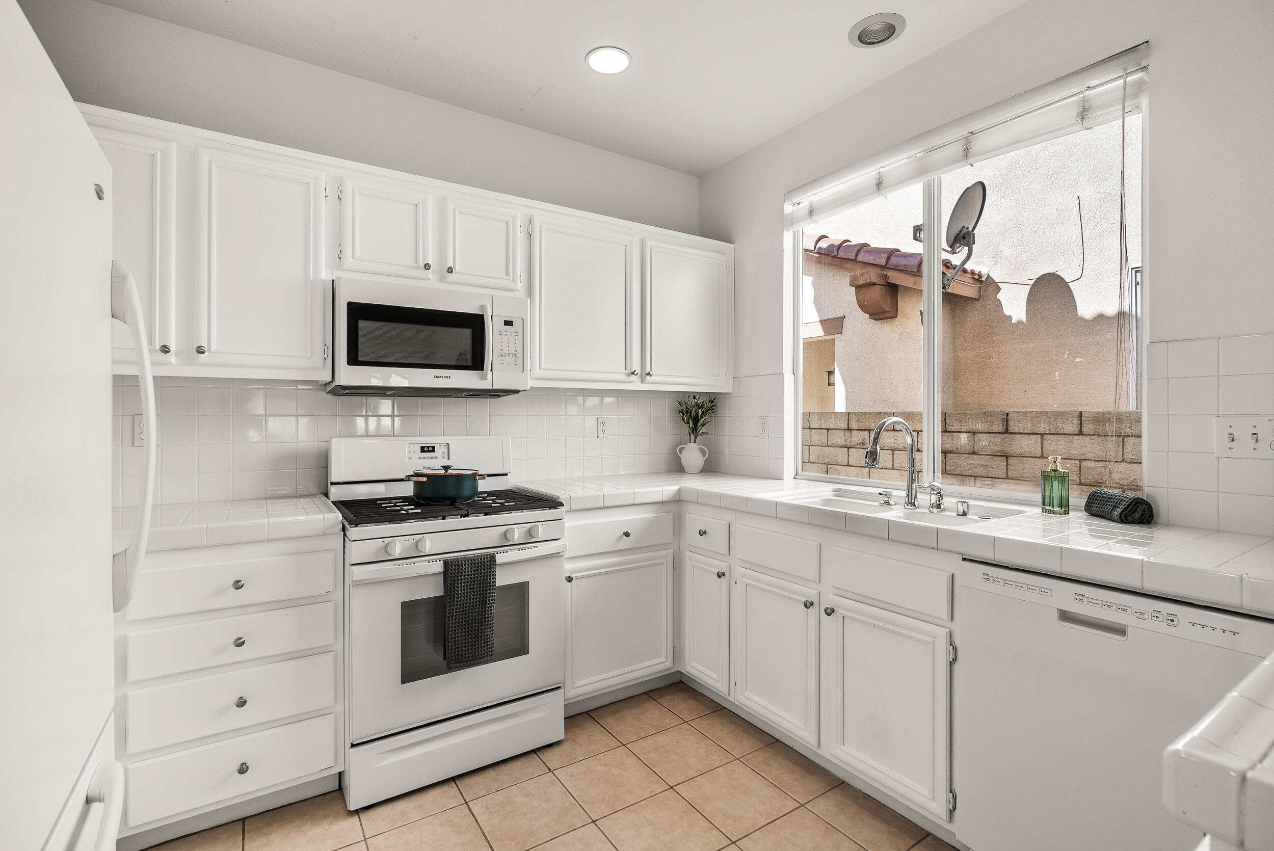 25803 Hammet Circle Stevenson Ranch, CA 91381 - Photo 12 of 32 a kitchen with white cabinets and appliances