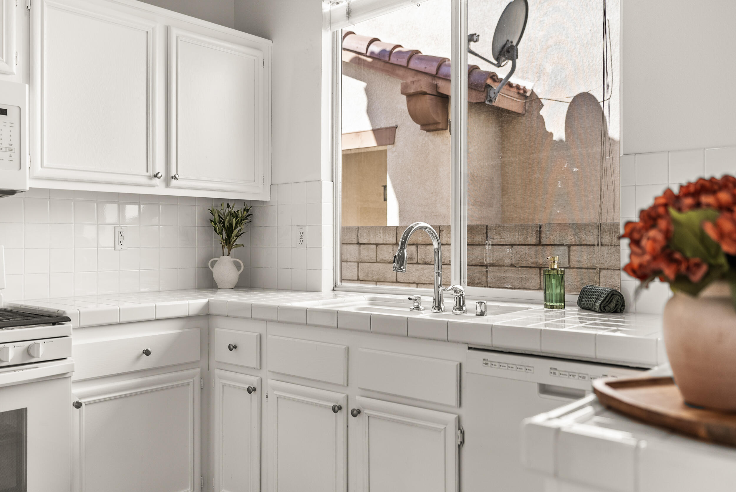 25803 Hammet Circle Stevenson Ranch, CA 91381 - Photo 14 of 32 a kitchen with a sink and cabinets