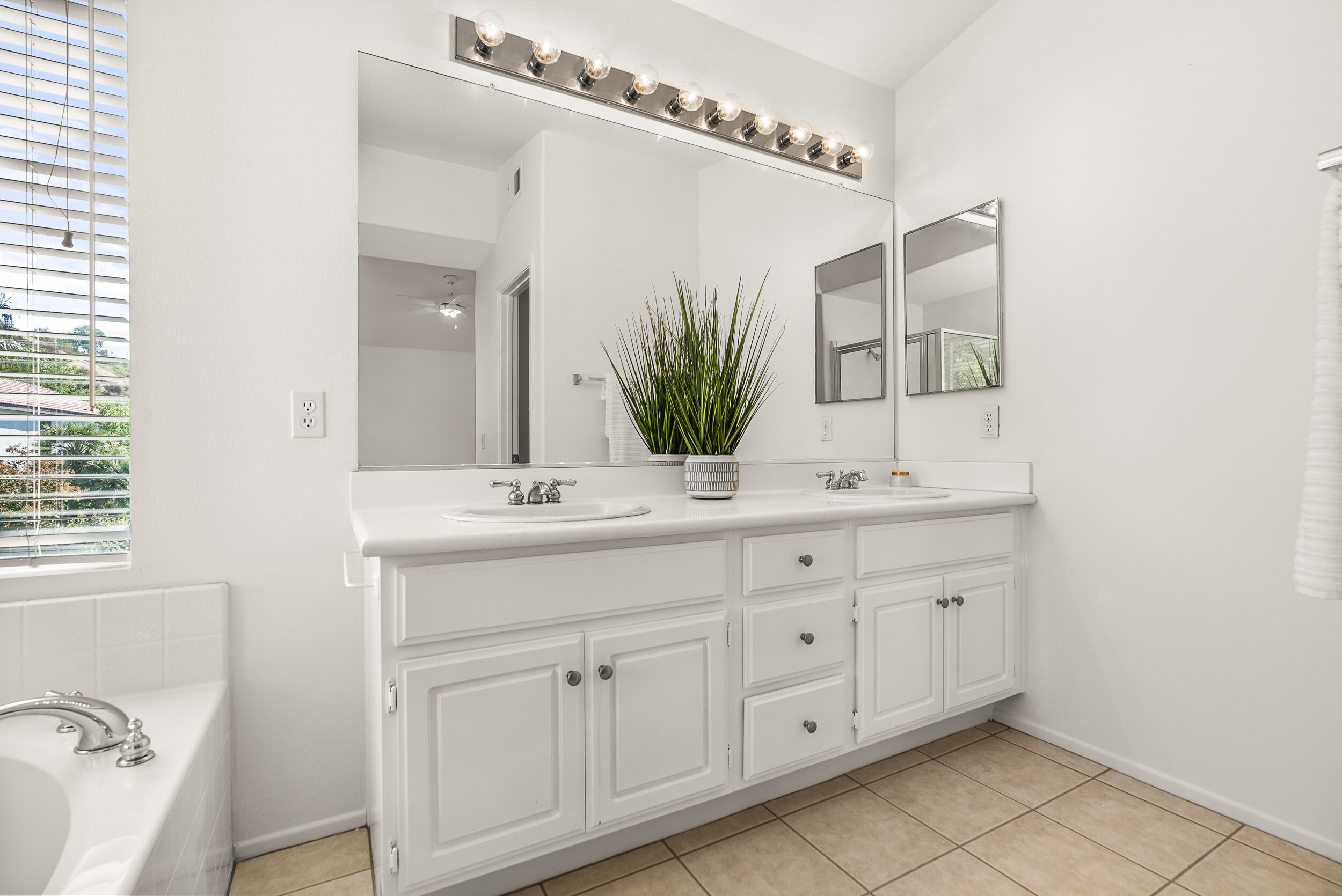 25803 Hammet Circle Stevenson Ranch, CA 91381 - Photo 22 of 32 a bathroom with a double vanity sink and a mirror