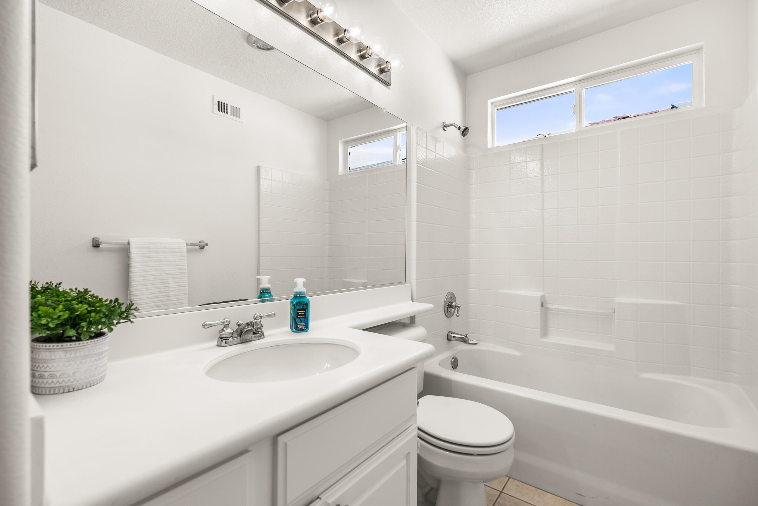 25803 Hammet Circle Stevenson Ranch, CA 91381 - Photo 26 of 32 a bathroom with a sink a toilet and a large mirror