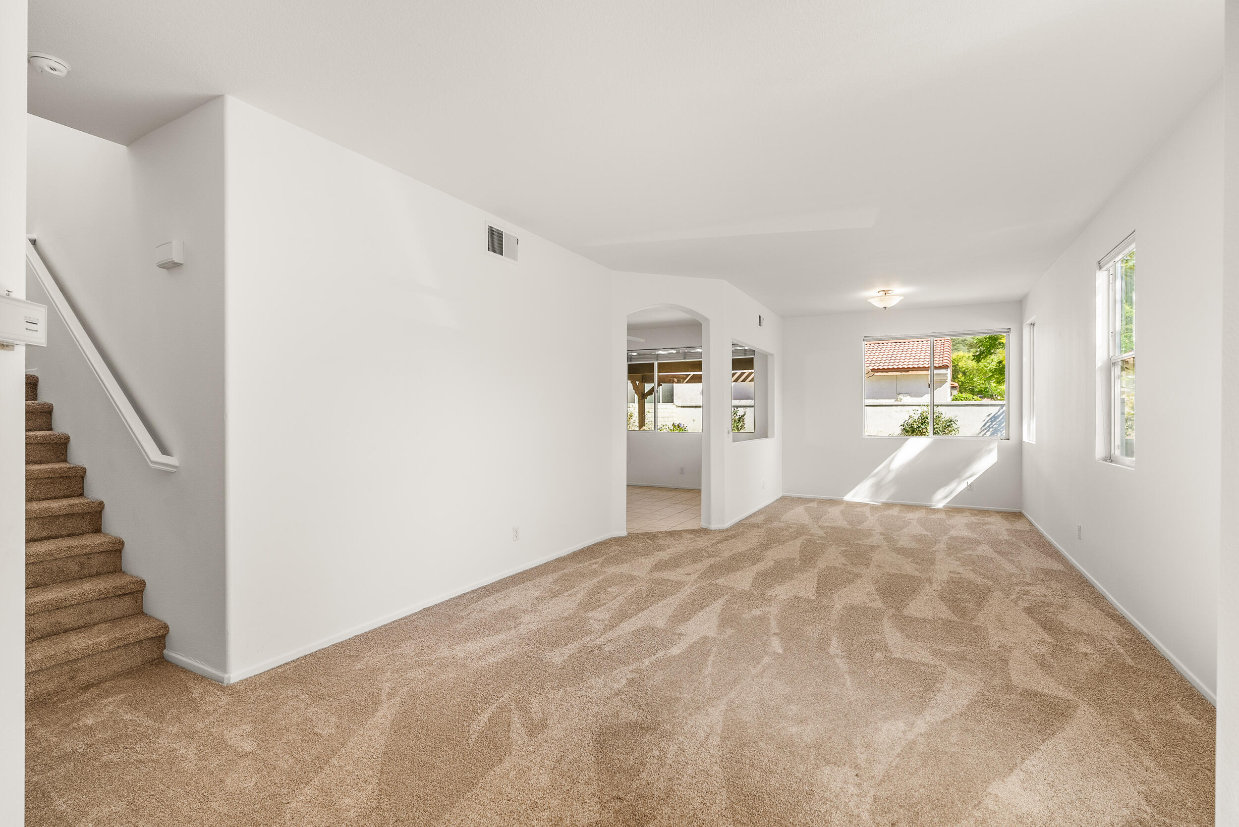 25803 Hammet Circle Stevenson Ranch, CA 91381 - Photo 4 of 32 a view of a bedroom with wooden floor and a hallway