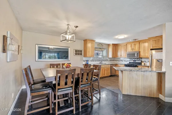 a large kitchen with a table and chairs