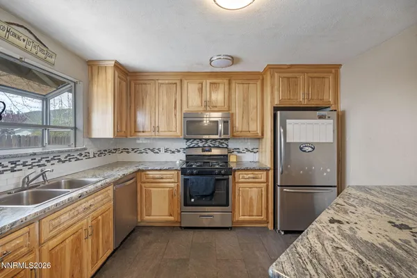 a kitchen with a sink stove and refrigerator